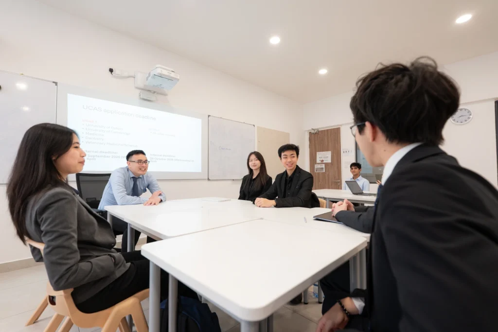 A tutor in discussion with Sixth Form students.