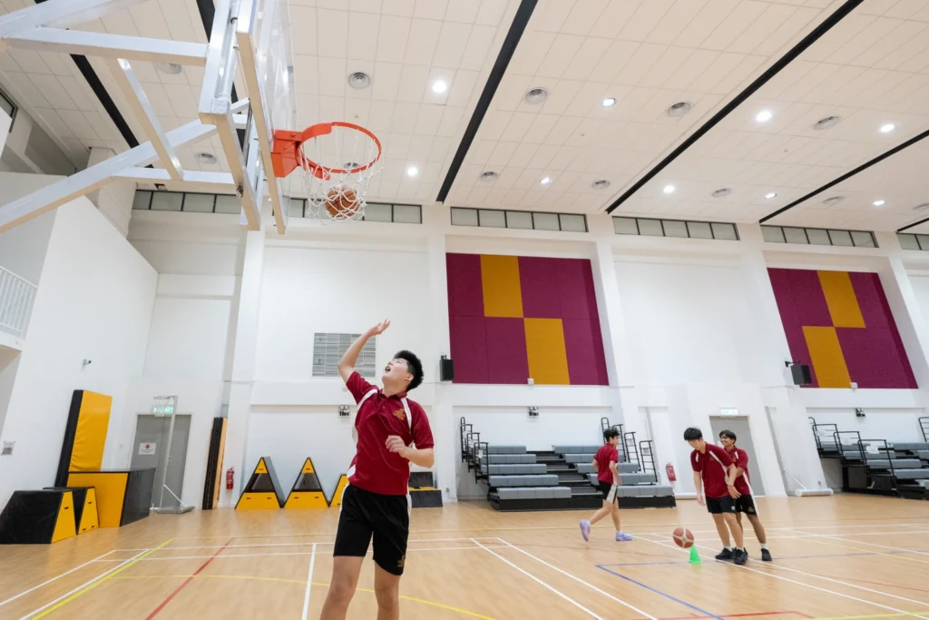 A student shoots for the hoop in the school sports hall.