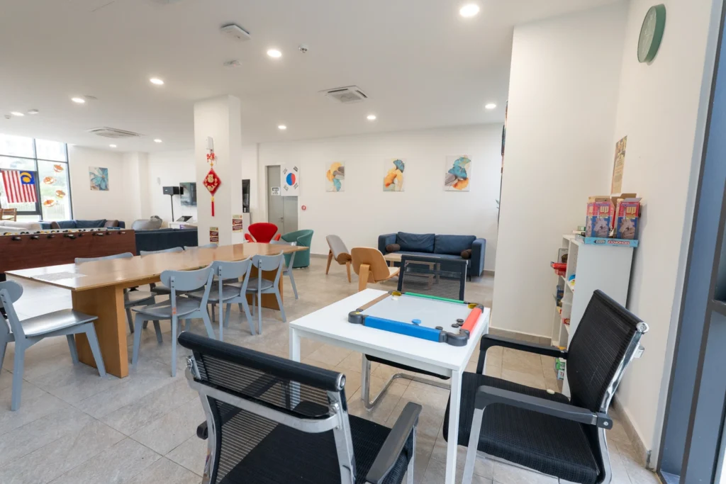 The boarding house lounge with board games, a table football table and seating.
