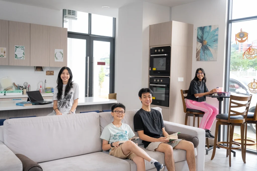 Boarders relax together on the sofa in the boarding house lounge.