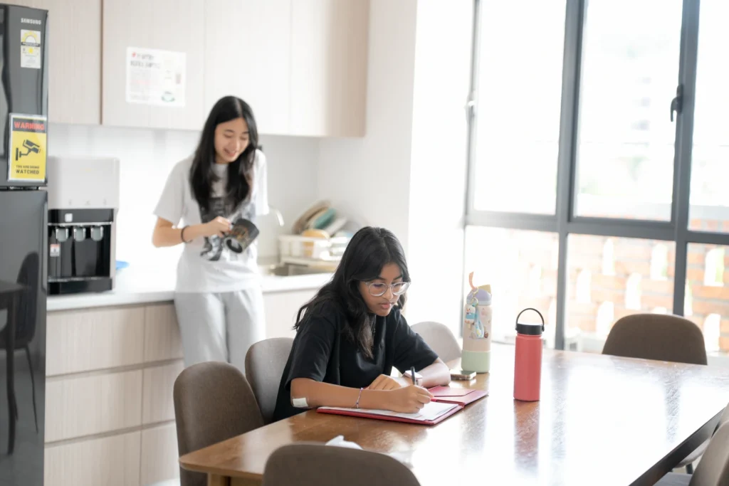 Boarders relax and study together in the shared kitchen and dining area.