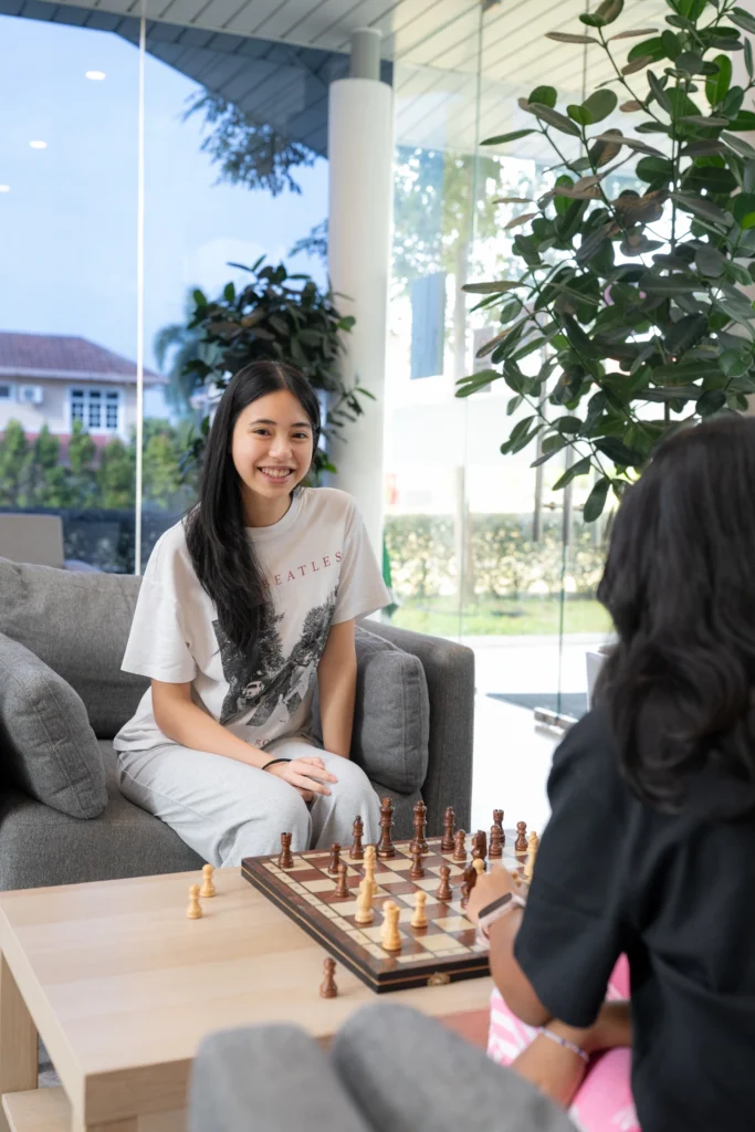 Two boarders play a game of chess together in the lounge.