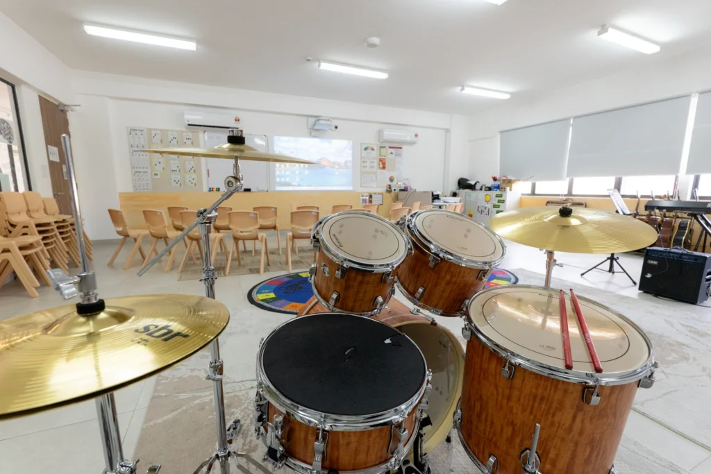 A music classroom with various percussion instruments set up in the center of the room.