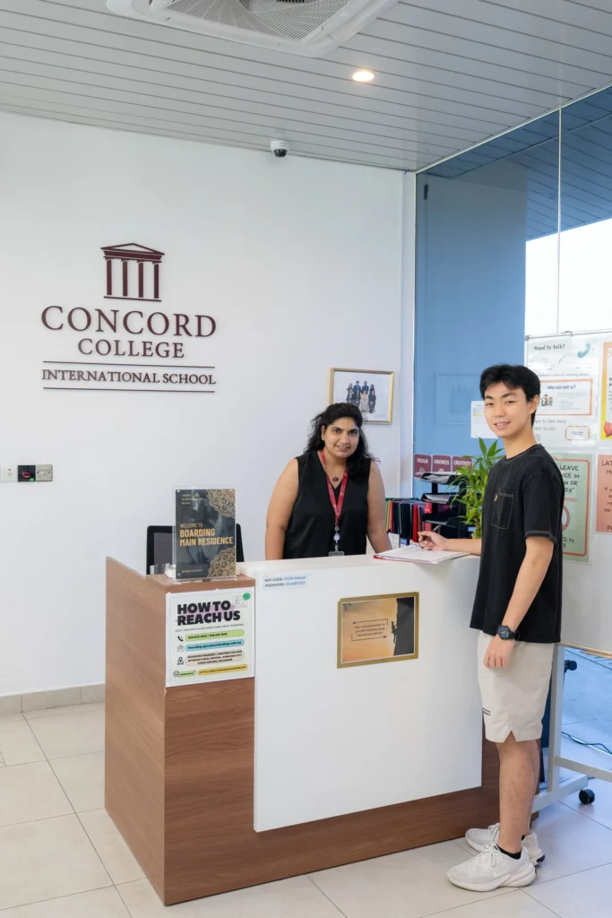 Students at the reception desk of the boarding house.