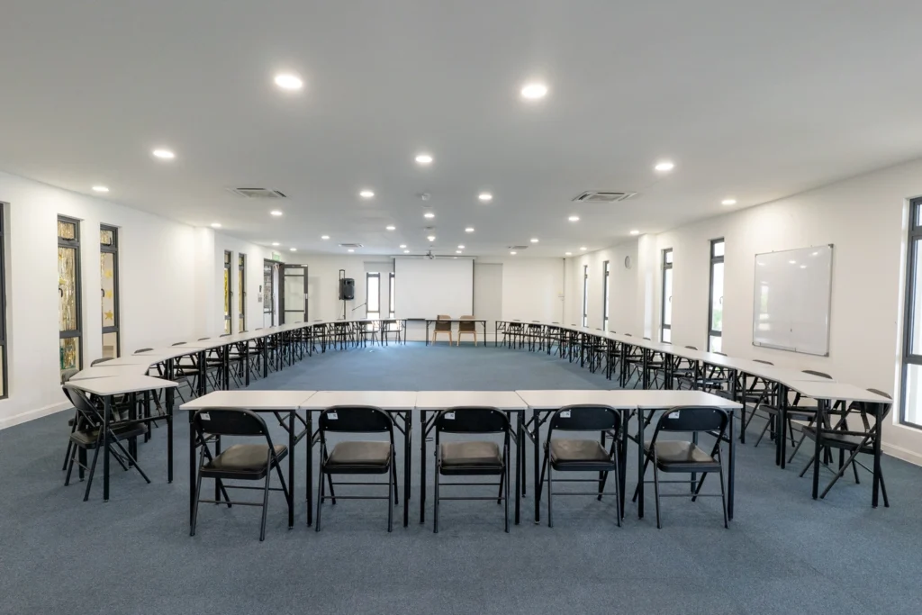 The examination hall set out with rows of desks and chairs.