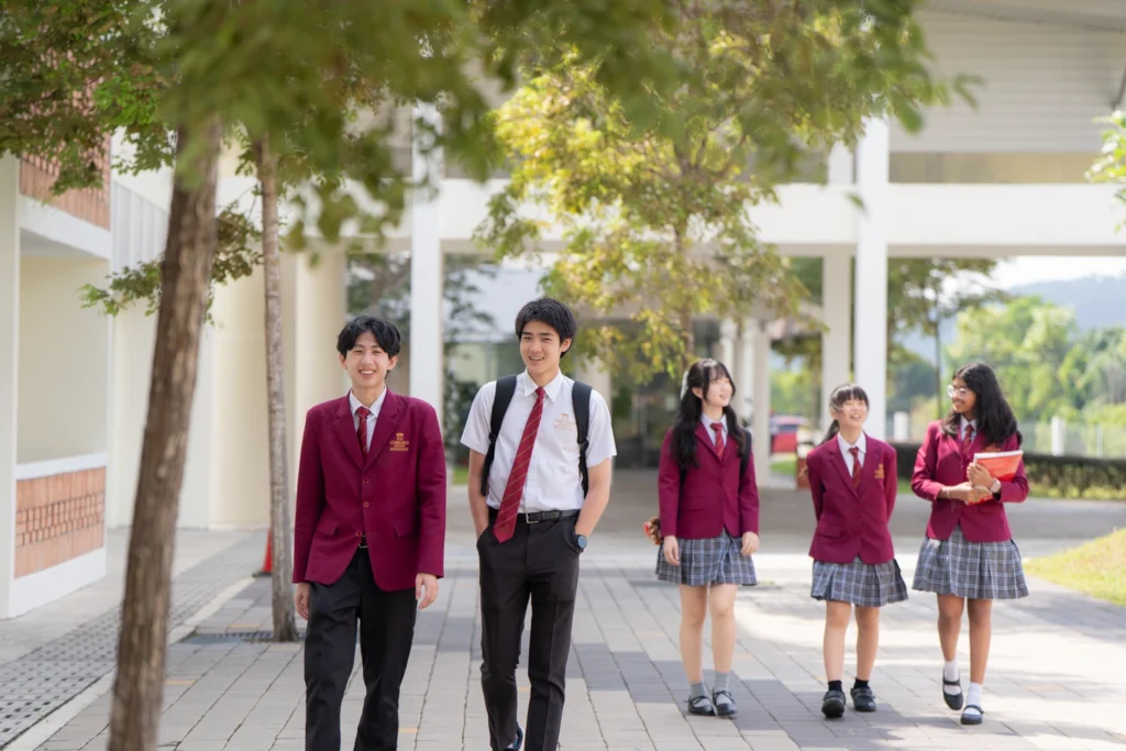 Students walking along the covered outdoor walkway by the boarding houses.