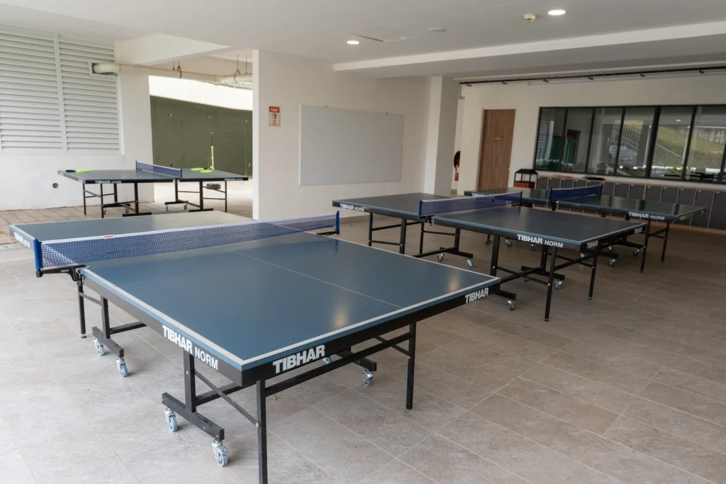 Table tennis tables set up in the recreation room.
