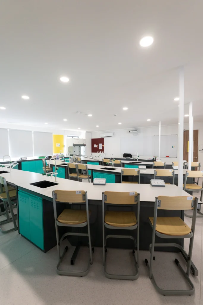 A science laboratory with fitted benches, stools and service outlets.