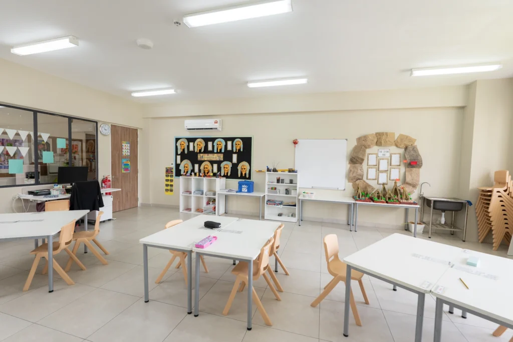 A Year 3 classroom with grouped tables and an Ancient Egypt topic display along the wall.